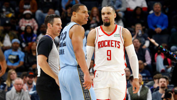 Grizzlies guard Desmond Bane (22) and Houston Rockets forward Dillon Brooks (9) are separated by a referee during the second half at FedExForum.